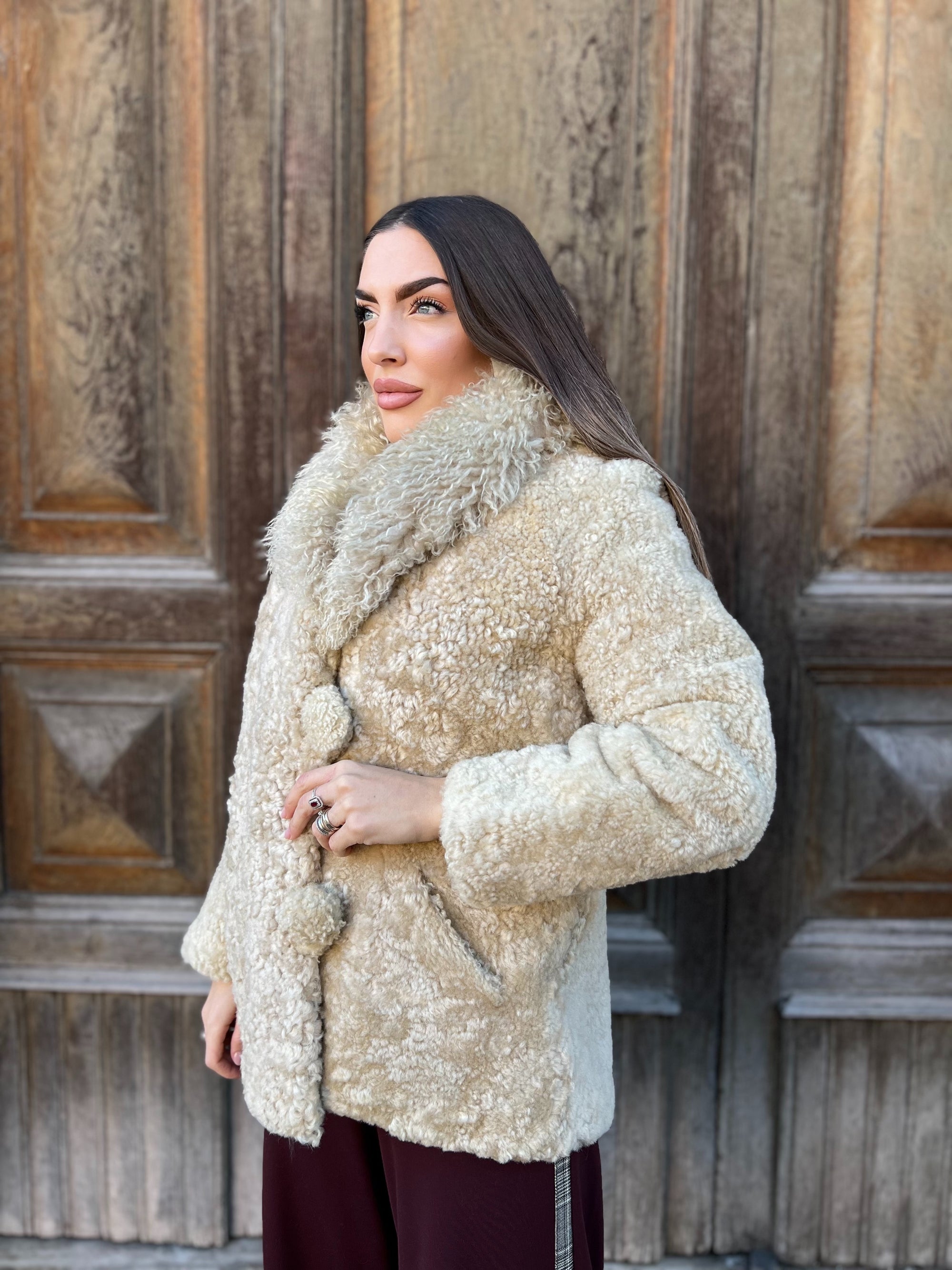 Fur coat of Astrakan cream with Mongolia neck