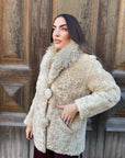 Fur coat of Astrakan cream with Mongolia neck