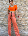 Pantalone palazzo in licra con cintura in vita - colore arancione